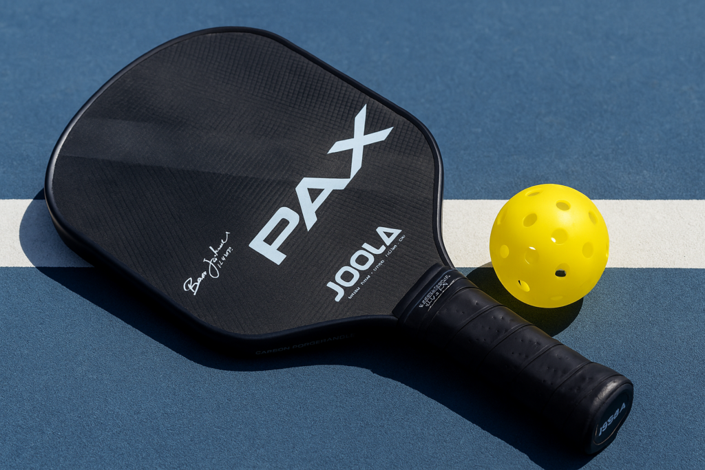 JOOLA Perseus paddle with yellow ball on blue court, representing one of the best pickleball paddles for intermediate players.
